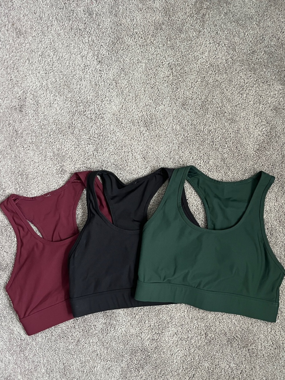 Fabletics Racerback Sports Bra Trio in Burgundy, Black & Forest Green